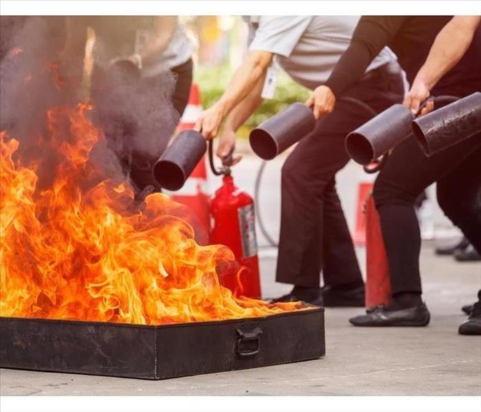 Thai people in the conflagration preventive extinguisher training program, Safety concept. Focus on fire tray.